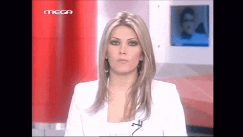 a woman in a white jacket stands in front of a sign that says mega