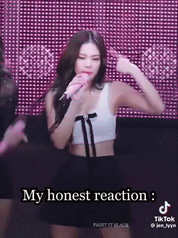 a woman singing into a microphone with the words my honest reaction