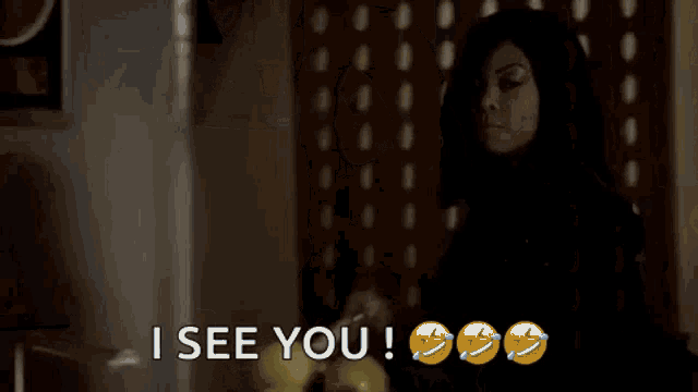 a woman in a black hoodie is holding a baseball bat and says `` i see you '' .