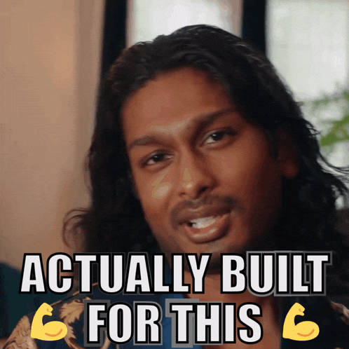 a man with long hair and a beard says " actually built for this " while flexing his muscles