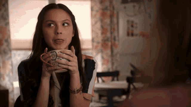 a woman is holding a cup that says " i love you "