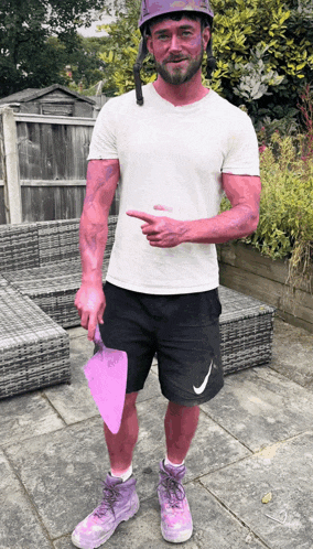 a man with pink paint on his arms and legs