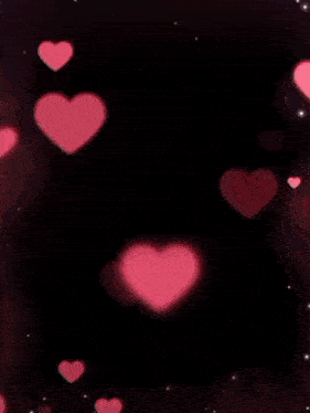 a man wearing sunglasses and a woman wearing a head scarf are surrounded by pink hearts