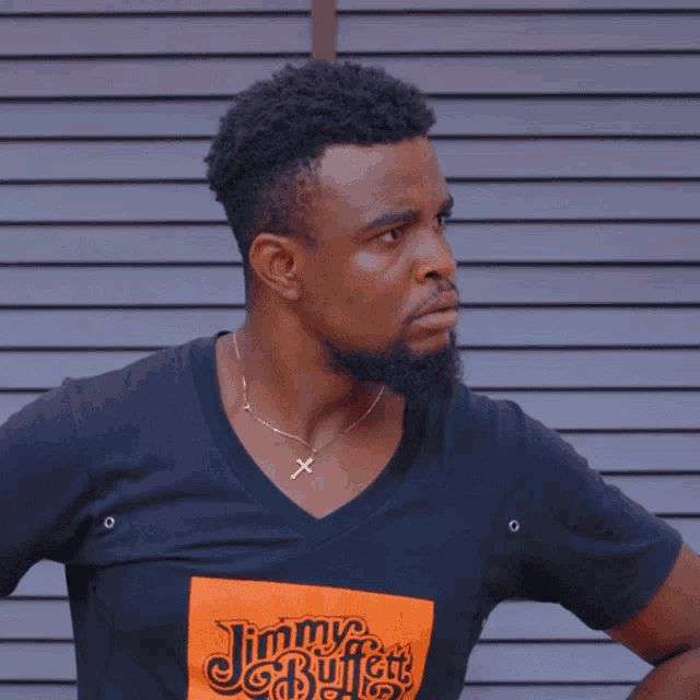 a man wearing a black t-shirt with the word huh on it