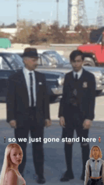 two men in suits and ties are standing next to each other with the words " so we just gone stand here "