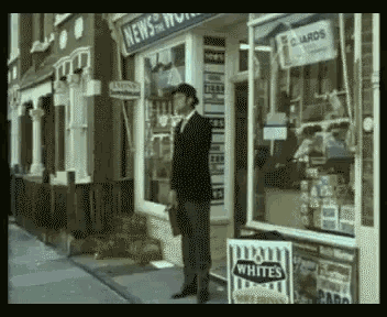 a man standing in front of a store that sells whites chips