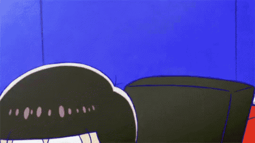 a close up of a cartoon character 's face against a blue wall .