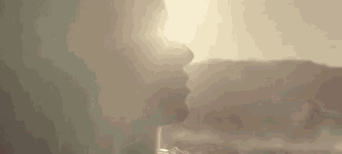 a close up of a person 's face with the sun shining through it .