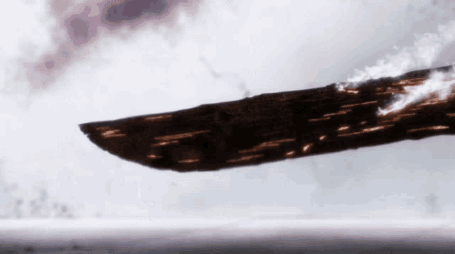 a knife is flying through the air with a blurred background