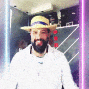 a man with a beard wearing a hat and a white jacket