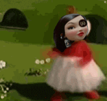 a cartoon doll is wearing a red and white dress and has a sticker on her eye .