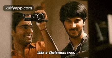 a man taking a picture of another man with a camera .