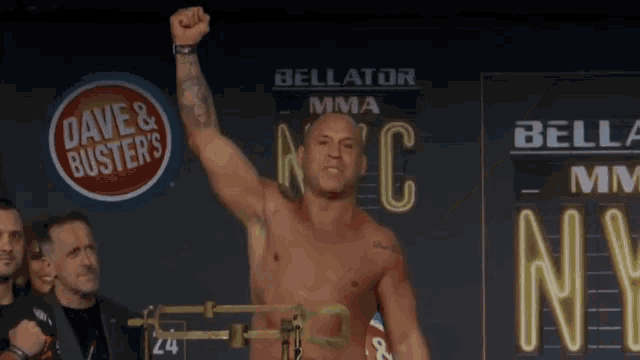 a man with his fist in the air in front of a sign that says bellator mma