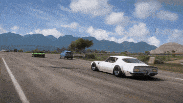 a white car is driving down a highway with other cars