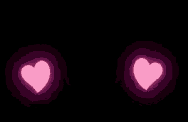 a pair of pink hearts glowing in the dark on a black background .