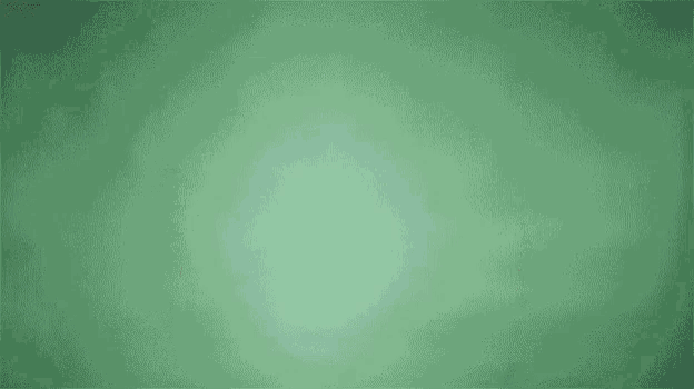 a man and a woman are jumping in the air against a green background .