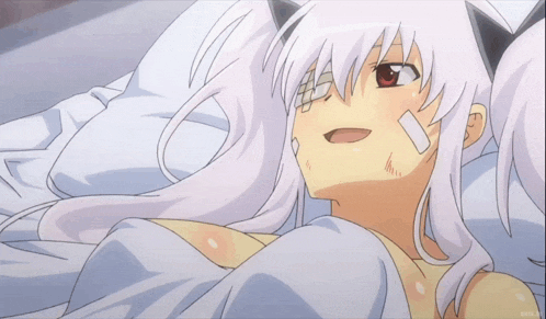 a girl with a bandage on her face is laying in a bed