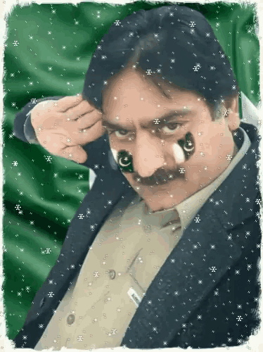 a man with pakistan flags painted on his face looks at the camera