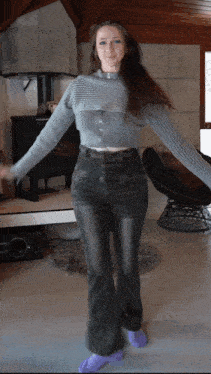 a woman wearing a grey sweater and purple socks