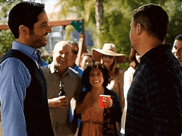 two men are standing next to each other talking to each other
