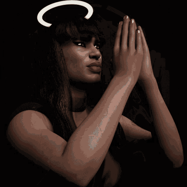 a woman with a halo on her head makes a heart shape with her hands