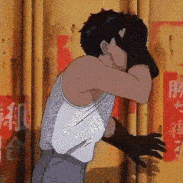 a man in a tank top and gloves is covering his face with his hands .