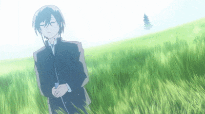 a boy in a suit is standing in a field of tall grass
