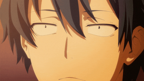 a close up of a person 's face with a slight smirk on their face