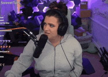 a woman wearing headphones sits in front of a microphone with sweettails written on the bottom
