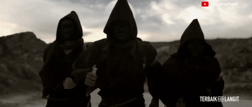 three people in hooded robes are standing in the desert with the words terbaik ke langit written on the bottom