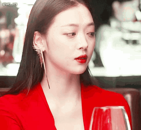 a woman in a red dress is holding a wine glass with the hashtag @wd_329