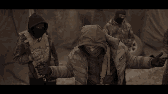 a person wearing a gas mask and a jacket with the word canada on it