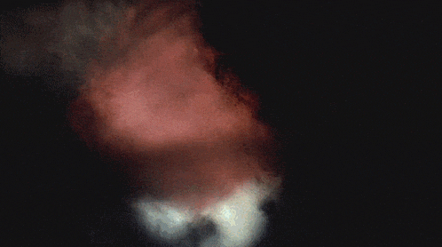a dark background with a pink smoke coming out of the bottom right corner