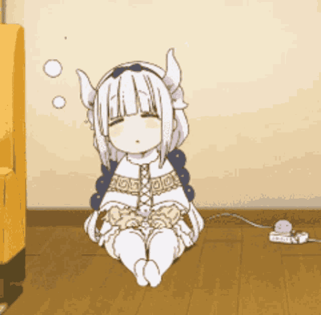 a girl with horns is sitting on the floor with her eyes closed .