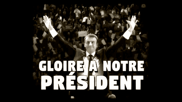a man in a suit and tie stands in front of a crowd with the words gloire a notre president below him