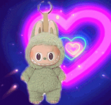 a stuffed animal in a bunny costume is standing in front of a heart