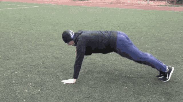 a man is doing push ups on a field