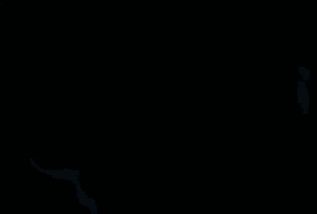 a person is smoking a cigarette in a dark room with smoke coming out of their mouth