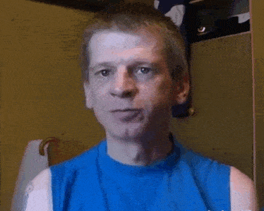 a man wearing a blue shirt that says ' a ' on it