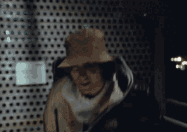 a blurry picture of a man wearing a hat and jacket