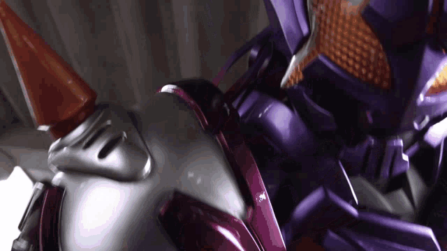 a close up of a purple robot with a red horn on its head