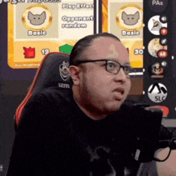 a man wearing glasses sits in front of a screen that says play effects