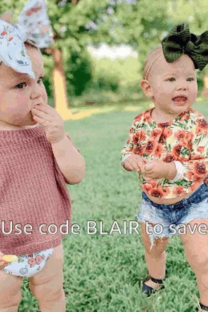 two babies are standing in the grass with the words use code blair to save