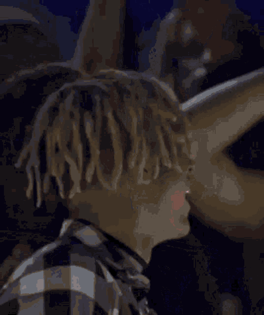 a pixel art of a man with red hair and dreadlocks