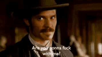 a man with a hat and mustache is saying are you gonna fuck with me .