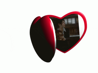 a heart shaped mirror with a woman in it
