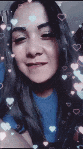 a woman in a blue shirt is surrounded by hearts on her hair