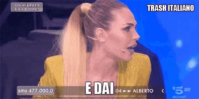 a woman in a yellow jacket is talking into a microphone and says e dai