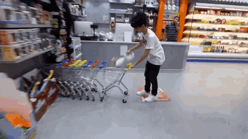 a man pushing a shopping cart in a store