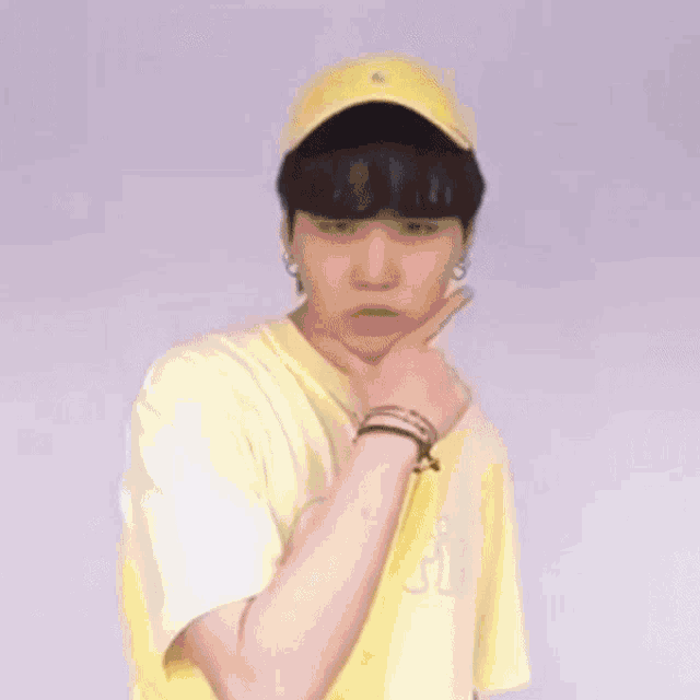 a yellow smiley face with a baseball cap on it